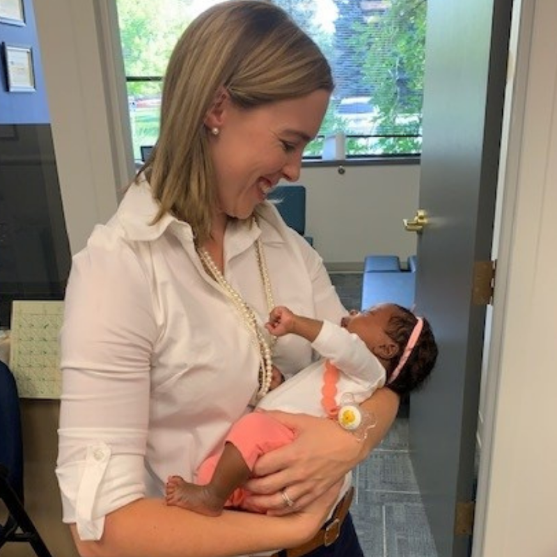 Dr. Ashley Campbell holding a baby on her arms